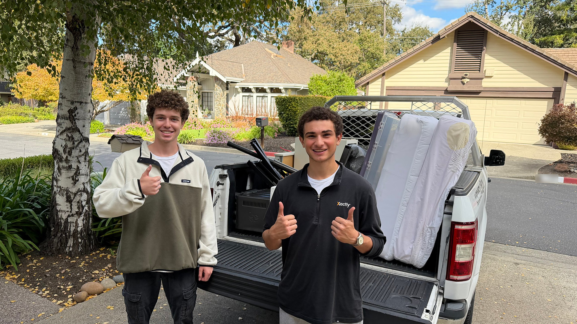 Louis and Max of Louis's Exterior Services with a truck loaded for a junk removal job